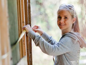 Student measuring for historic preservation project